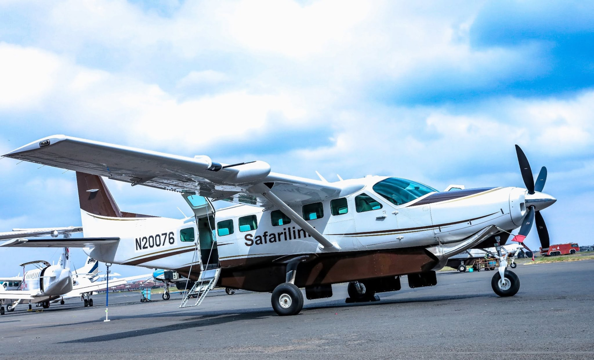Safarilink Cessna Caravan on the apron with the airstair door open for boarding