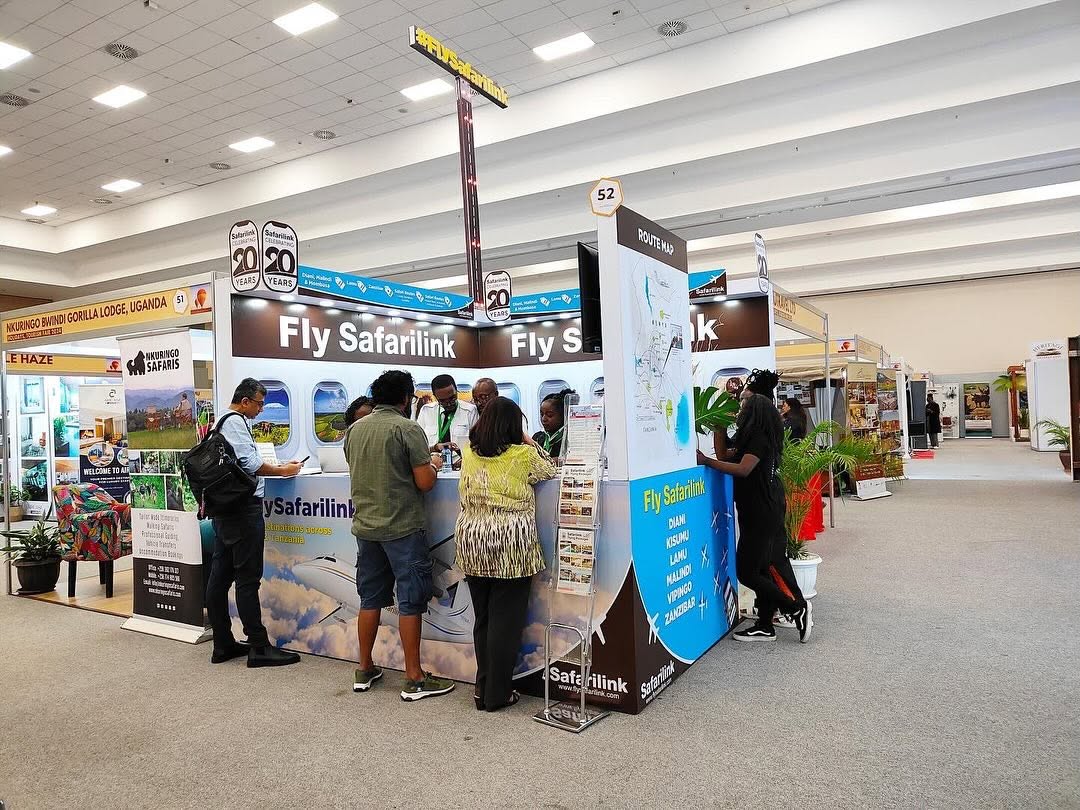 Travellers speaking with Safarilink crew at the Fly Safarilink travel expo stand